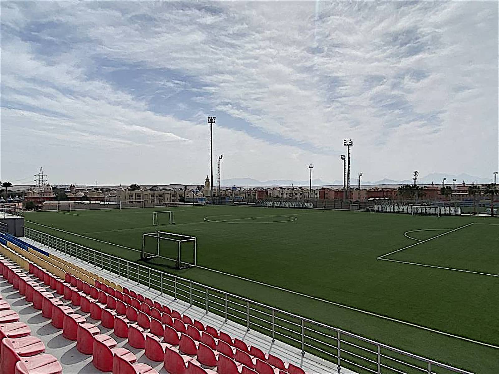 Completed football stadium at Senzo Club with red stands.