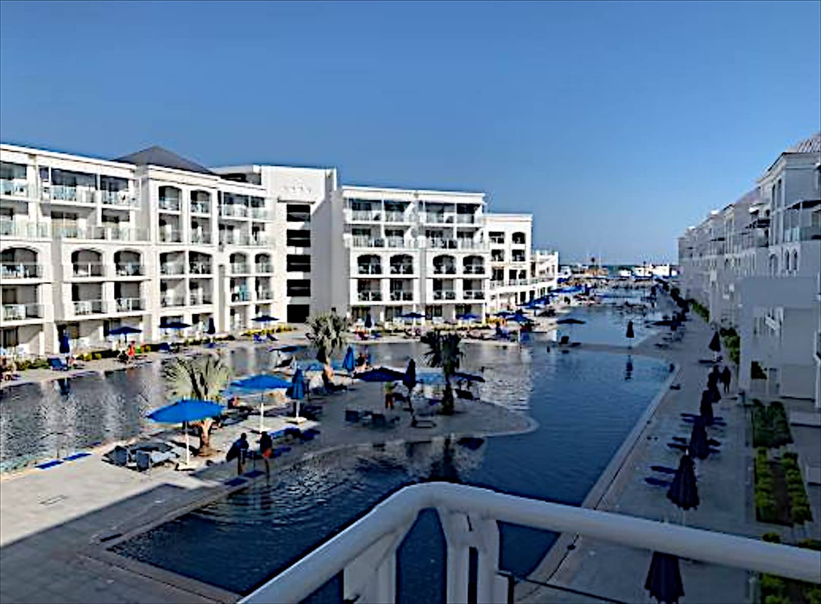 Lagoon pool and guest blocks at Blu Spa Resort from a balcony.