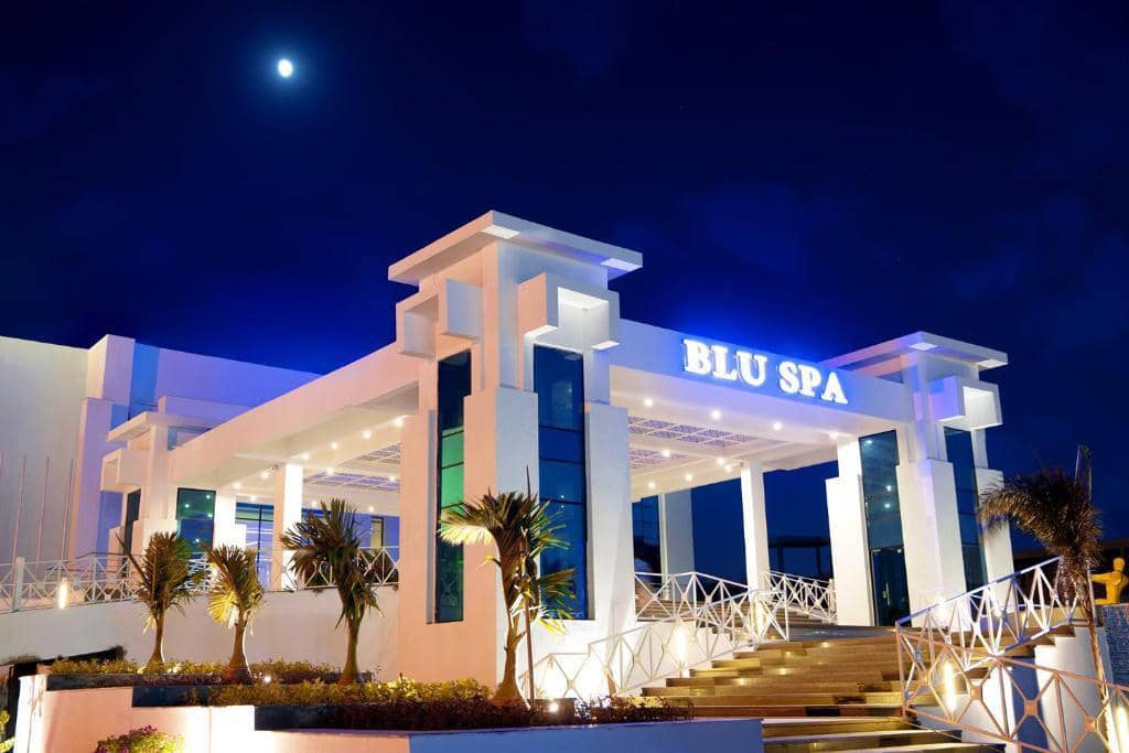Illuminated entrance of Blu Spa Resort in Hurghada at dusk.