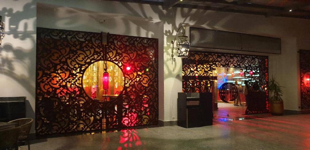Hotel corridor interior with arched lighting.